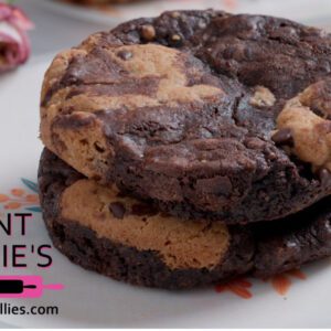 Close-up of a double chocolate chip cookie with a bite taken out.