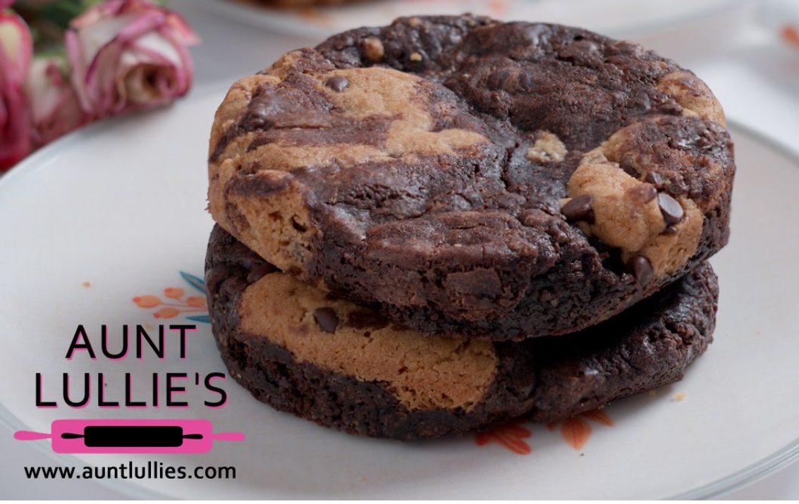 Close-up of a double chocolate chip cookie with a bite taken out.