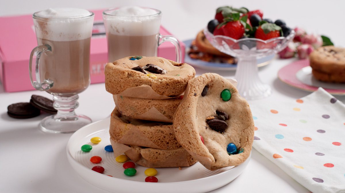 Stack of colorful candy-studded cookies on a plate.