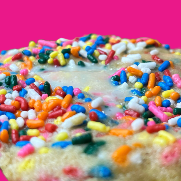 A close up of sprinkles on top of a cookie.