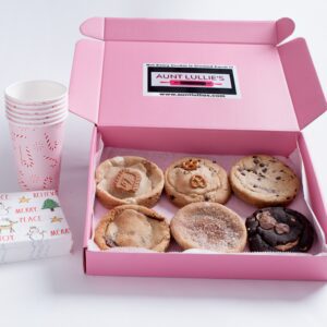 Pink box with assorted cinnamon rolls and pink party cups.